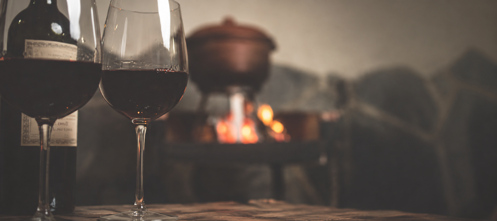 Muted title image for Contentment, showing wine glasses in front of a softly blurred fire.