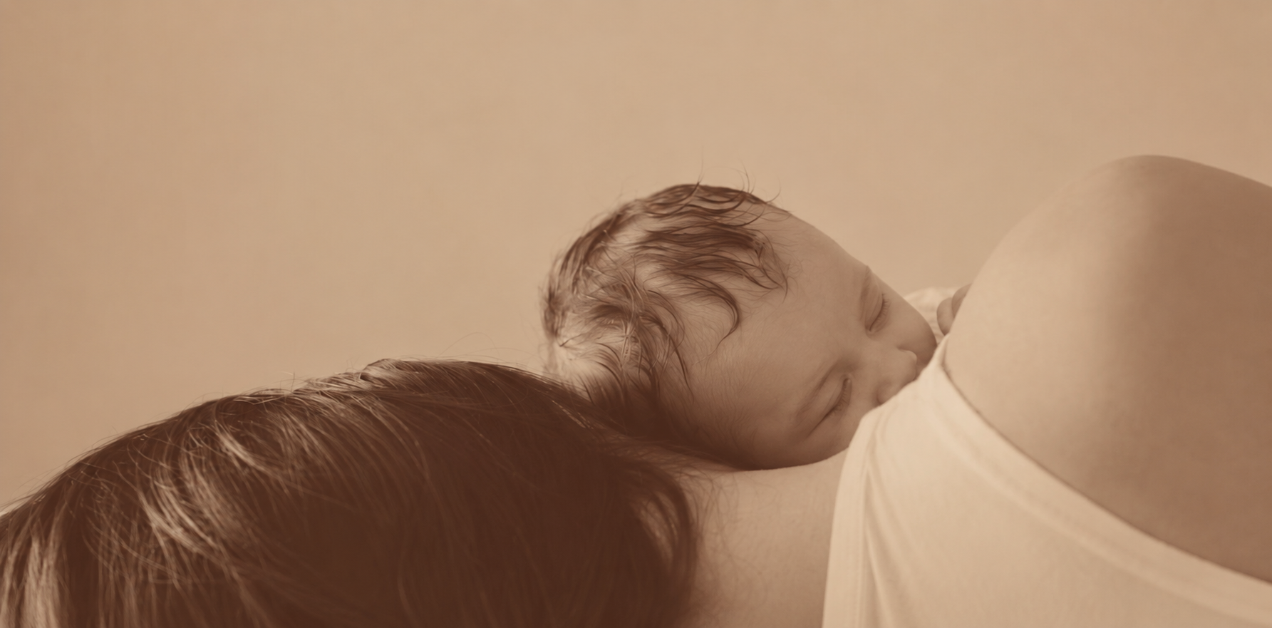 Sepia-toned title image for Mama in the Village, showing a child resting against an adult.